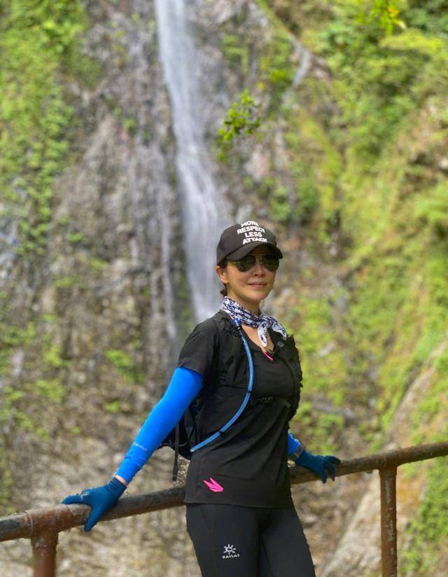 54岁刘嘉玲外出度假，冒大雨站挖掘机上热舞，掌