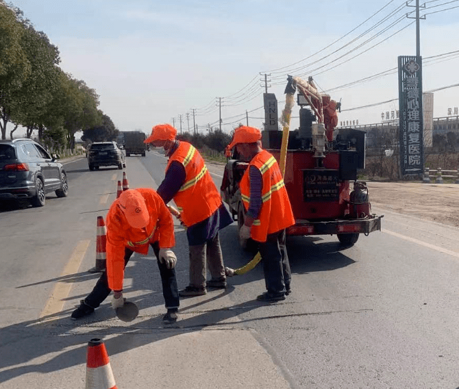 各条国省干线公路上,养护工人在补坑槽,灌养缝,整路肩,扫路面.