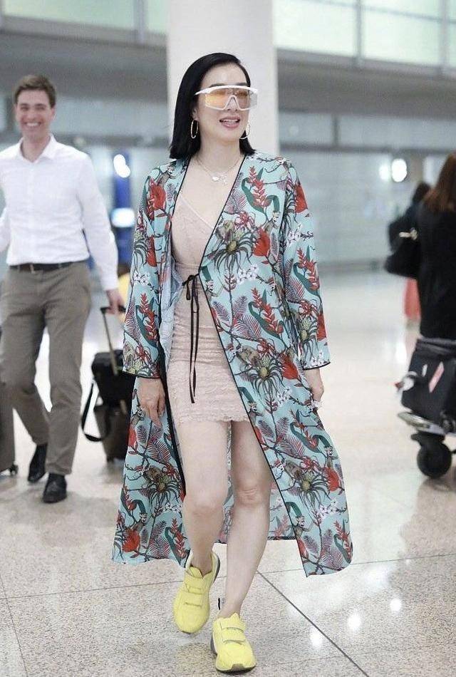 睡袍|钟丽缇机场造型收敛不少！身材丰满穿超短裤，硬穿白丝袜却有点土
