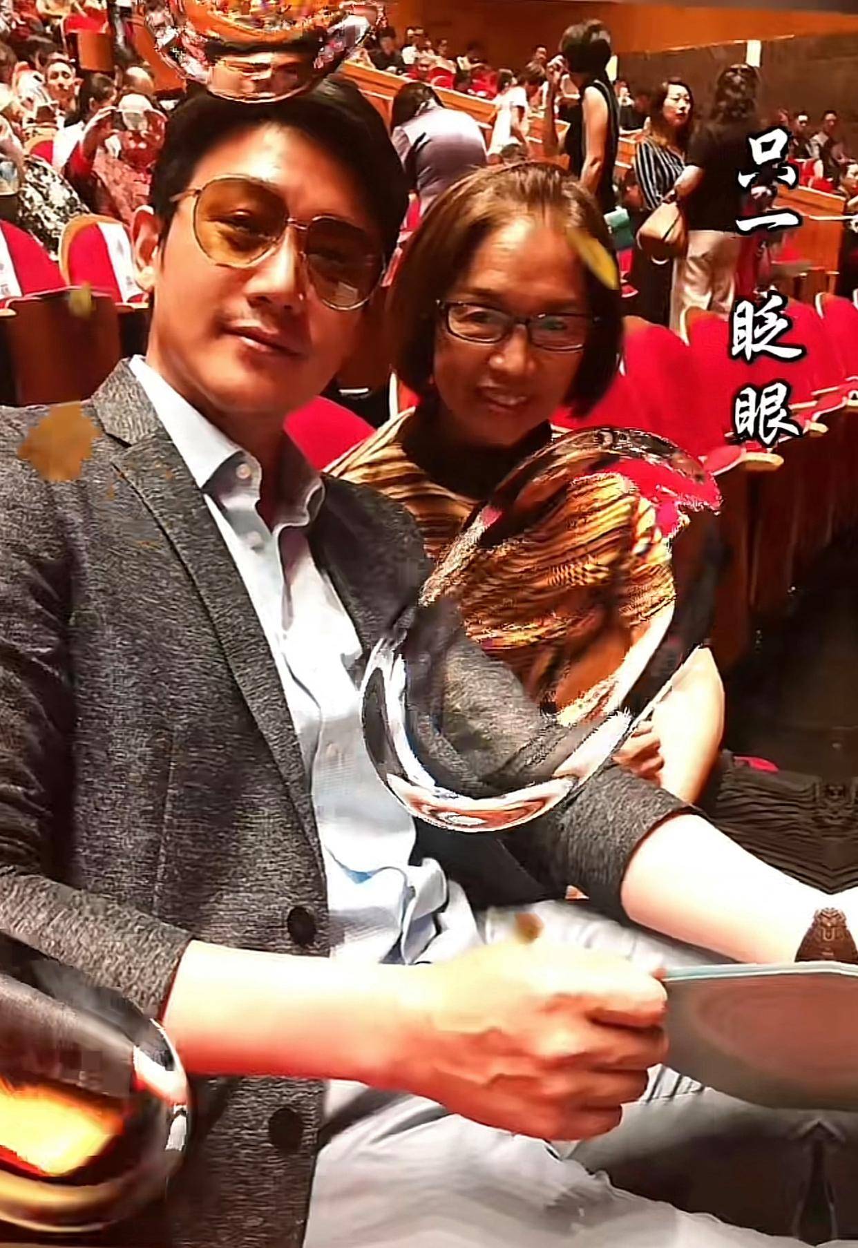 照片中47岁的陆毅站在妈妈的身后搂着妈妈和两个女儿亲密合影一
