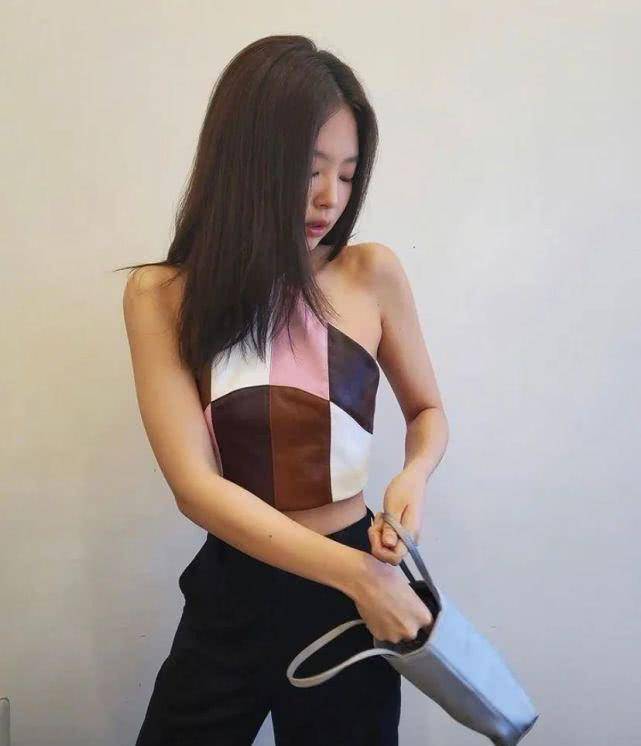 下装搭配的是紧身的黑色长裤,中分长直发的jennie让